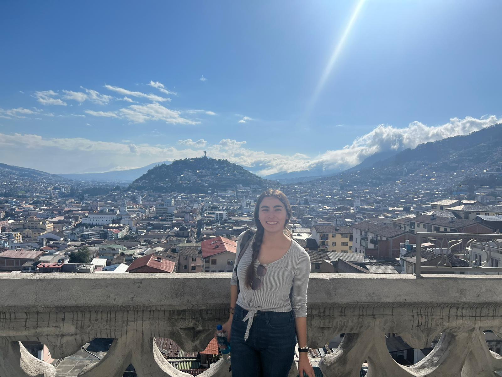 Student studying in Ecuador poses in front of Quito